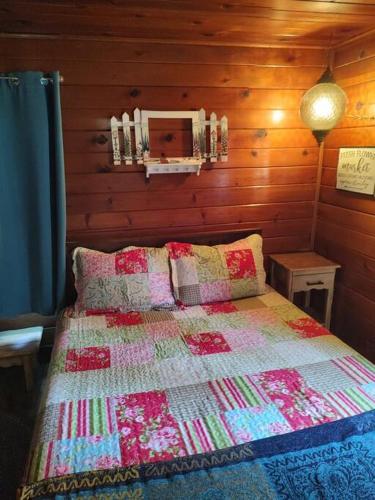a bedroom with a bed with a quilt on it at O'Brien's Oasis in Miramonte