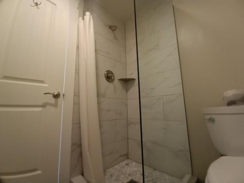a bathroom with a shower and a toilet at Yellowstone Riverside Cottages in Gardiner