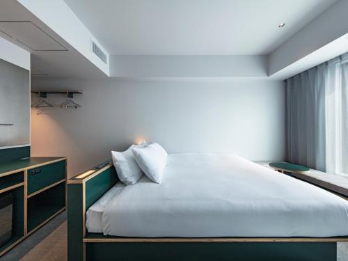 Кровать или кровати в номере all day place shibuya