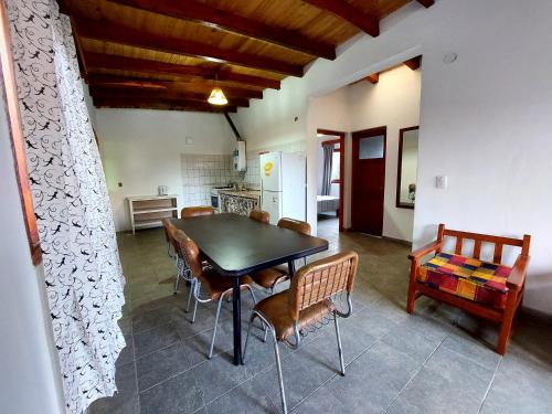 a kitchen and dining room with a table and chairs at Hostal killari in Cafayate