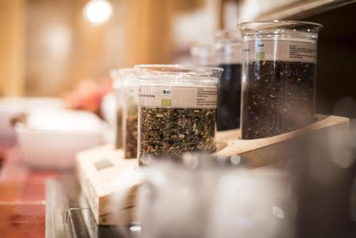 three jars of seeds are sitting on a table at Alpenpension Pfurtscheller in Neustift im Stubaital