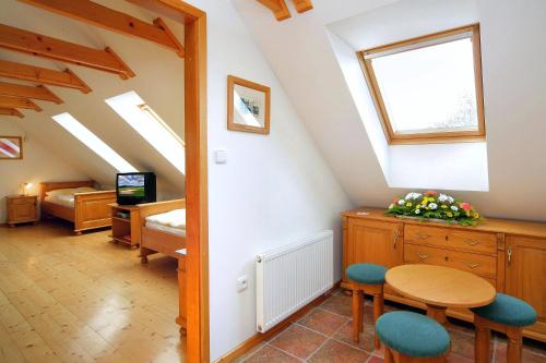 a room with a bed and a table and chairs at Penzion Kovárna in Bukvice