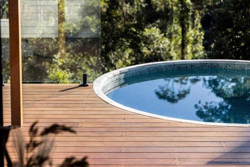 a swimming pool sitting on a wooden deck at Pool House Bellingen in Fernmount