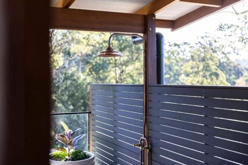 a porch with a window and a lamp at Pool House Bellingen in Fernmount