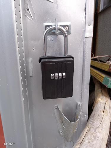 a metal refrigerator with a lock on the side of it at 下田市旧南豆 in Shimoda