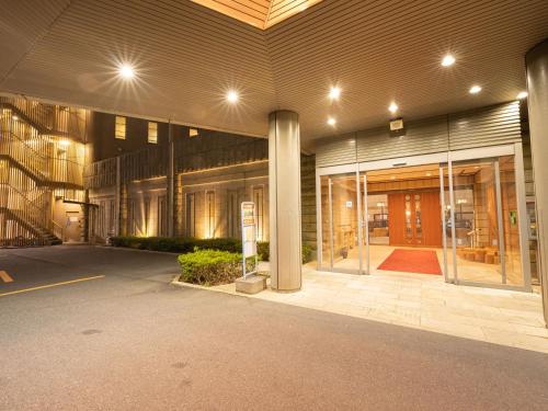 a large building with a lobby with glass doors at KAMENOI HOTEL Atami in Atami