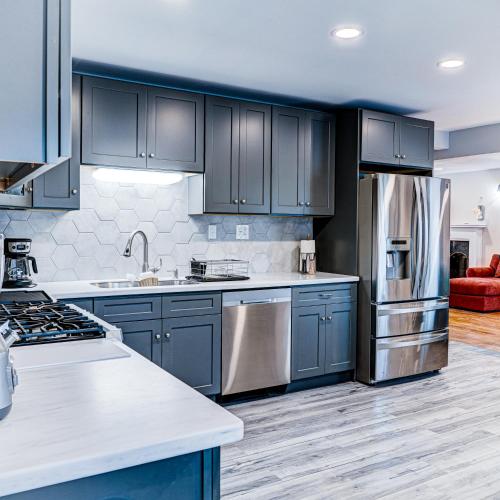 a kitchen with blue cabinets and a stainless steel refrigerator at Winner's Getaway in Norwich