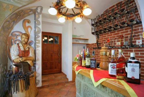 a room with a bar with a statue of a man at Penzion Kovárna in Bukvice