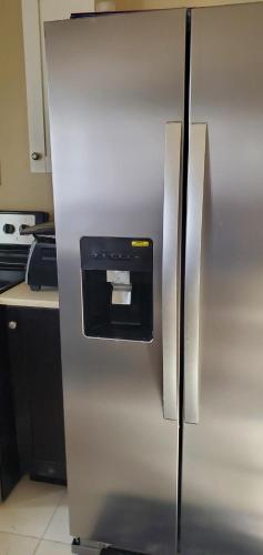 a stainless steel refrigerator with a dispenser on it at Hillside Sunrise, 2 Bed 2 Bath in Gated Community, close to beach, food, clubs & shopping Free Parking, Free Wi-Fi in Montego Bay