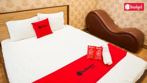 a bed with red and white pillows on it at Bich Thu Hotel in Ho Chi Minh City