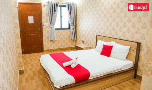 a bedroom with a bed with a stuffed animal on it at Bich Thu Hotel in Ho Chi Minh City