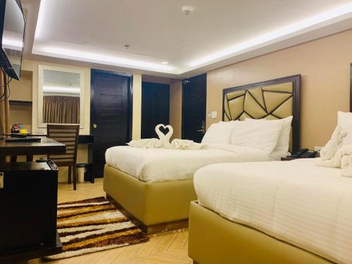 Ένα ή περισσότερα κρεβάτια σε δωμάτιο στο Treasure Island Hotel With Mini Water Adventure