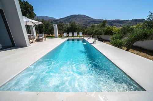 a swimming pool in the backyard of a house at Villa Vivian Heated Private Swimming Pool & Jacuzzi in Georgioupolis