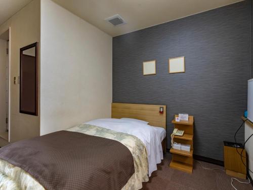 Postel nebo postele na pokoji v ubytování Tabist Hotel Kurama Hikone
