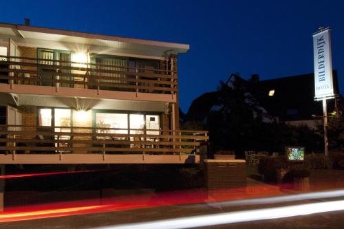 a building with a balcony on the side of a street at Hotel Bilderdijk in De Haan
