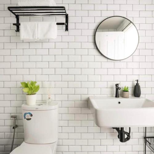 a white bathroom with a toilet and a sink at Cozy A at Nimman Studio Room in Condominium in Chiang Mai
