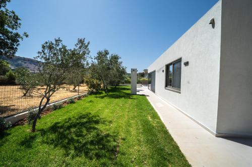 a view of a yard next to a building at Villa Vivian Heated Private Swimming Pool & Jacuzzi in Georgioupolis