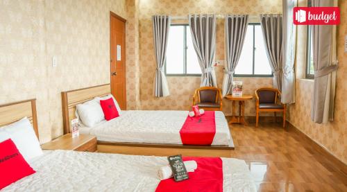a hotel room with two beds with red pillows at Bich Thu Hotel in Ho Chi Minh City