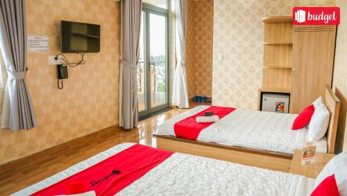 a hotel room with two beds and a television at Bich Thu Hotel in Ho Chi Minh City