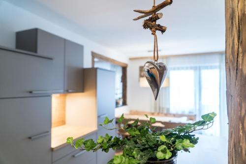 a kitchen with a potted plant and a crucifix at Appartement Wiederkehr in Flachau