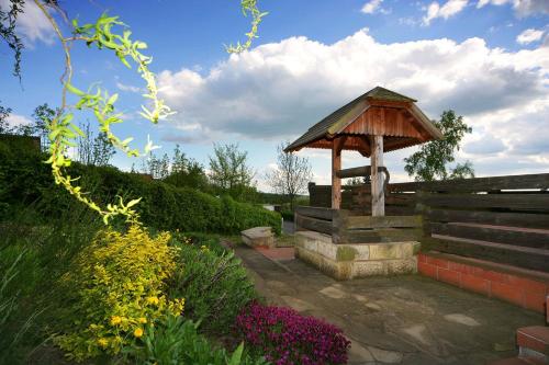 a gazebo in the middle of a garden at Penzion Kovárna in Bukvice