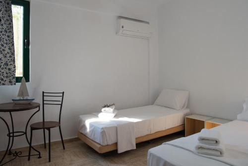 a bedroom with a bed and a table and chairs at Villa Flisvos in Marathias