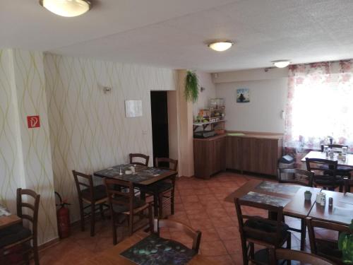 a restaurant with tables and chairs in a room at Hotel Zur Rose in Bad Karlshafen