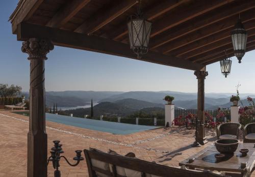 a patio with a table with a view of the mountains at Casa Vesta in Zufre
