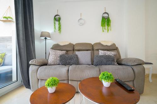 a living room with two tables and a couch at Apartment 3d Albir in Albir