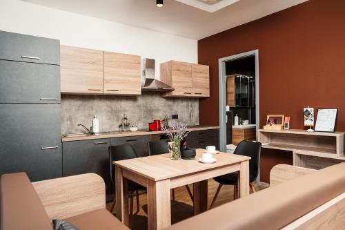a kitchen and dining room with a wooden table at Wine paradise Glavinič in Miklavž pri Ormožu