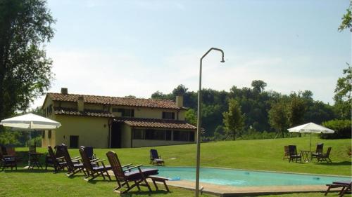 a group of chairs sitting around a swimming pool at MAGNOLIA e CAMELIA in Vicchio