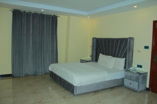 a bedroom with a bed with a gray headboard at Move-N-Pick Murree in Murree