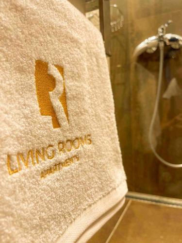 a towel with the number seven on it next to a shower at Living Rooms in Skopje