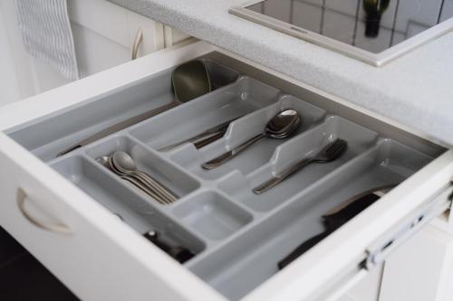 a kitchen drawer with utensils in it at Moon Garden Old Town Hotel in Vilnius