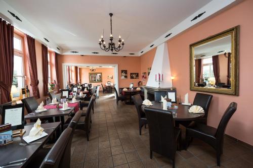 a dining room with tables and chairs and a mirror at Hotel Südlohner Hof - Ristorante Da Fabio in Südlohn