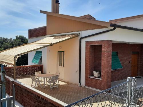a patio with a table and chairs on a deck at RESIDENCE ACCORDEON in Castelfidardo