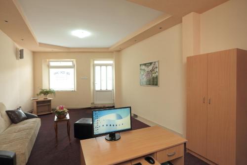 a living room with a tv and a couch at Apartments Bokan in Cetinje