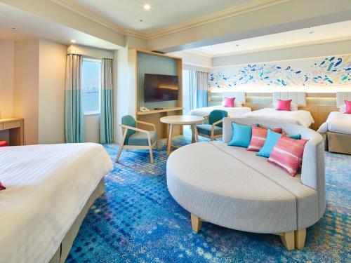 a hotel room with two beds and a couch at Grand Nikko Tokyo Bay Maihama in Urayasu