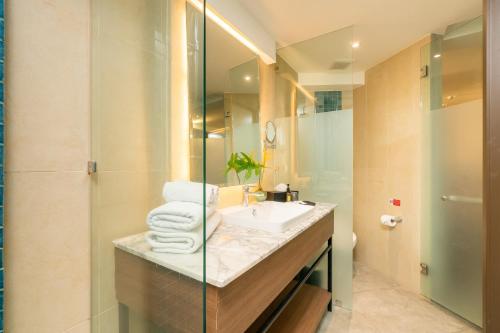 a bathroom with a sink and a shower at Dewa Phuket Resort & Villas, Nai Yang Beach in Nai Yang Beach