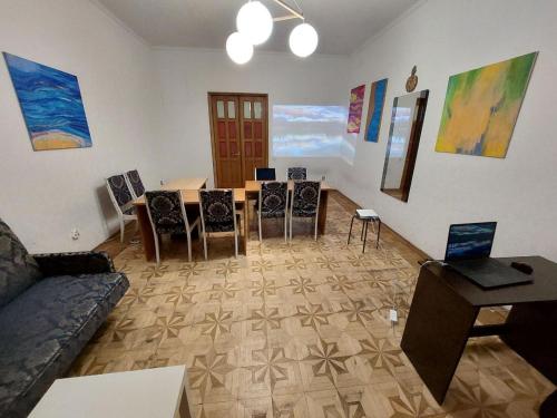 a living room with a table and chairs at Alabama in Kyiv
