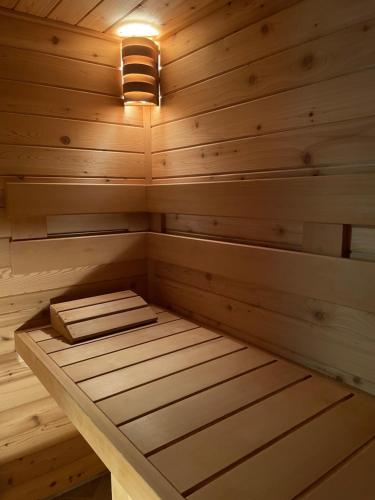 a wooden sauna with a light on top of it at Penzion Kovárna in Bukvice