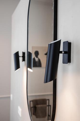 a mirror on a wall with a reflection of a man at Villa Ostinato in Ostend