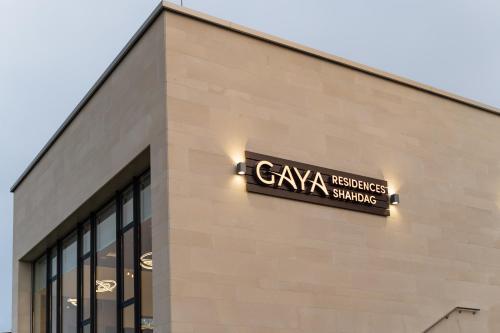 a sign on the side of a building at Gaya Residences in Shahdag