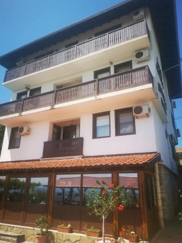an external view of a building with a balcony at Family Hotel Arbanashka Sreshta in Arbanasi
