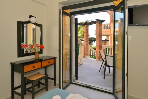 a room with a glass door leading to a balcony at Maria Beach Hotel in Kissamos