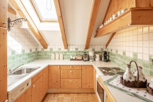 a kitchen with wooden cabinets and a sink and a window at Centro 7 - Kristall Lungau in Tamsweg
