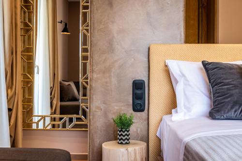 a bedroom with a bed and a mirror at AGNONTAS LUXURY VILLAS in Agnontas