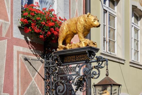 a statue of a bear on a sign on a building at Zum Roten Bären in Freiburg im Breisgau