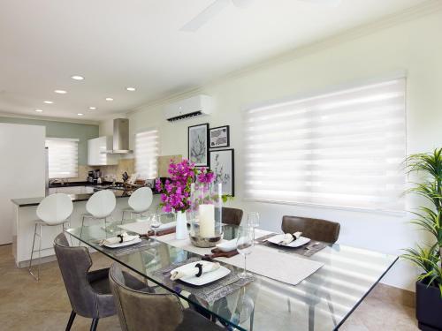a dining room with a glass table and chairs at Zenbreak KingsGate 1 in Saint Peter