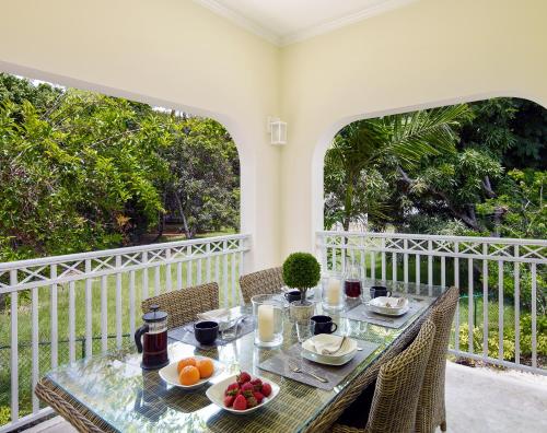 a table with a bowl of fruit on a balcony at Zenbreak KingsGate 1 in Saint Peter